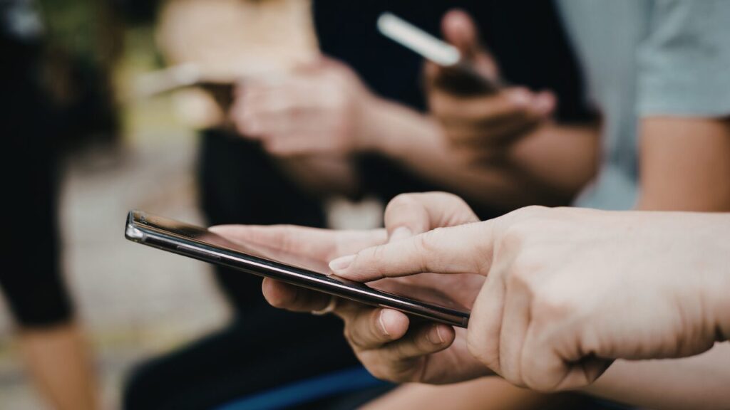 People using mobile devices together